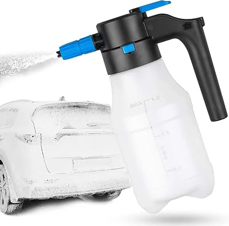 A pump sprayer with a blue nozzle spraying fine mist next to a car covered in white foam