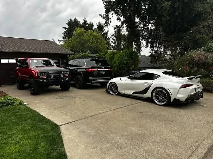 Seth's Toyota Supra, right-hand-drive Land Cruiser and SUV in his driveway